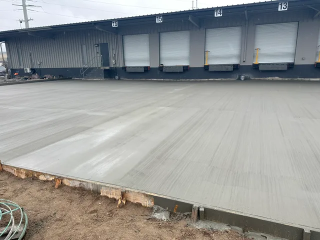 Finished concrete slab beside a warehouse